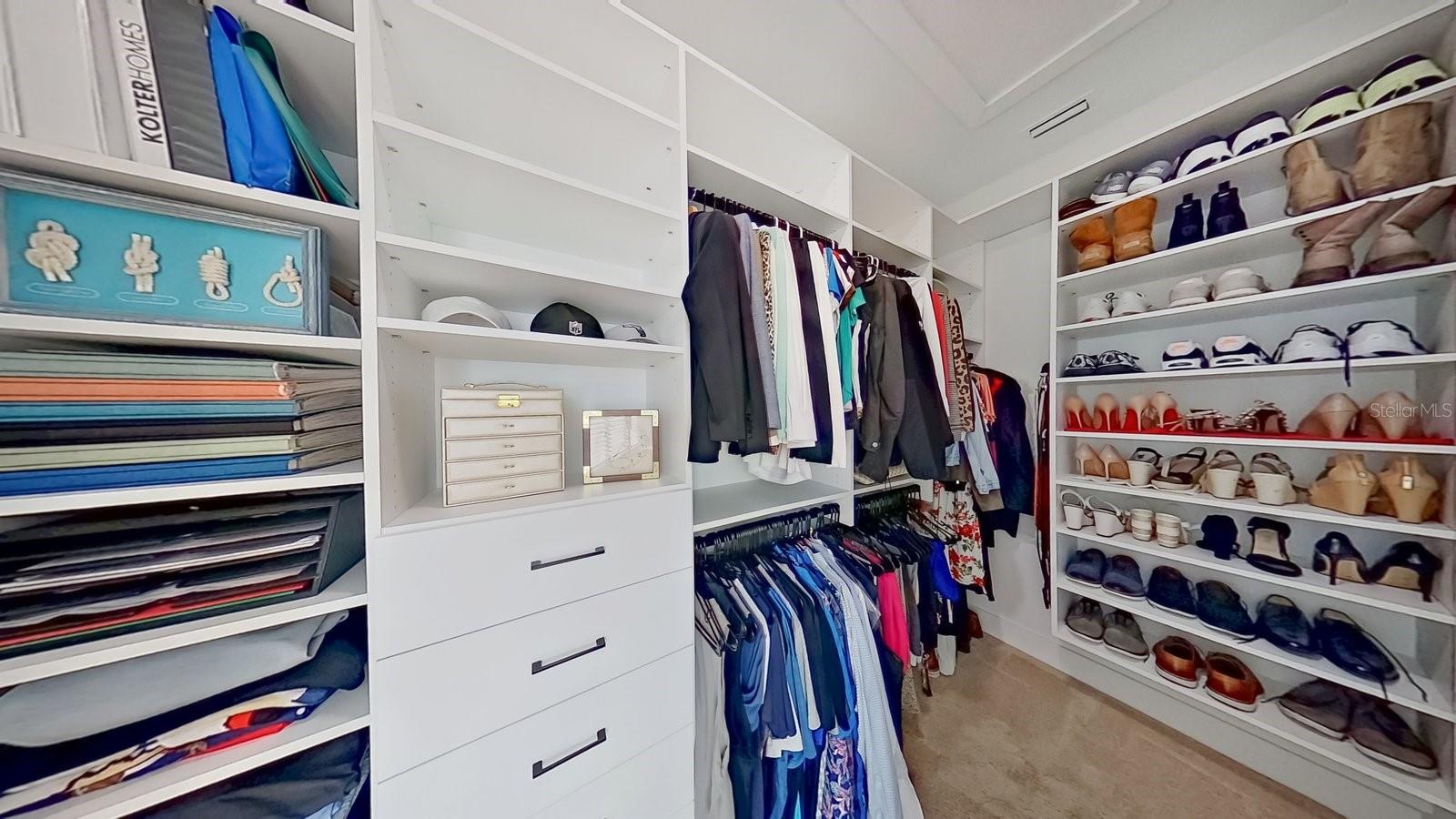 Primary Suite features custom walk-in closet built by California Closets