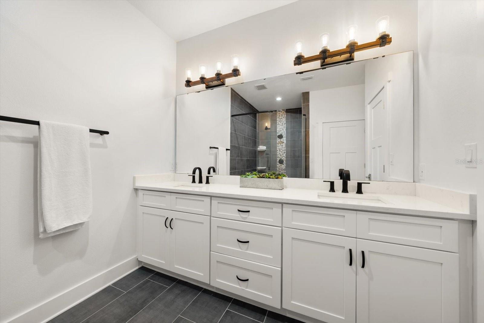 Primary Suite features custom walk-in closet built by California Closets