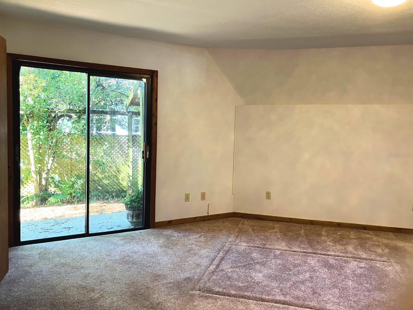 Primary bedroom sliding doors to garden paths