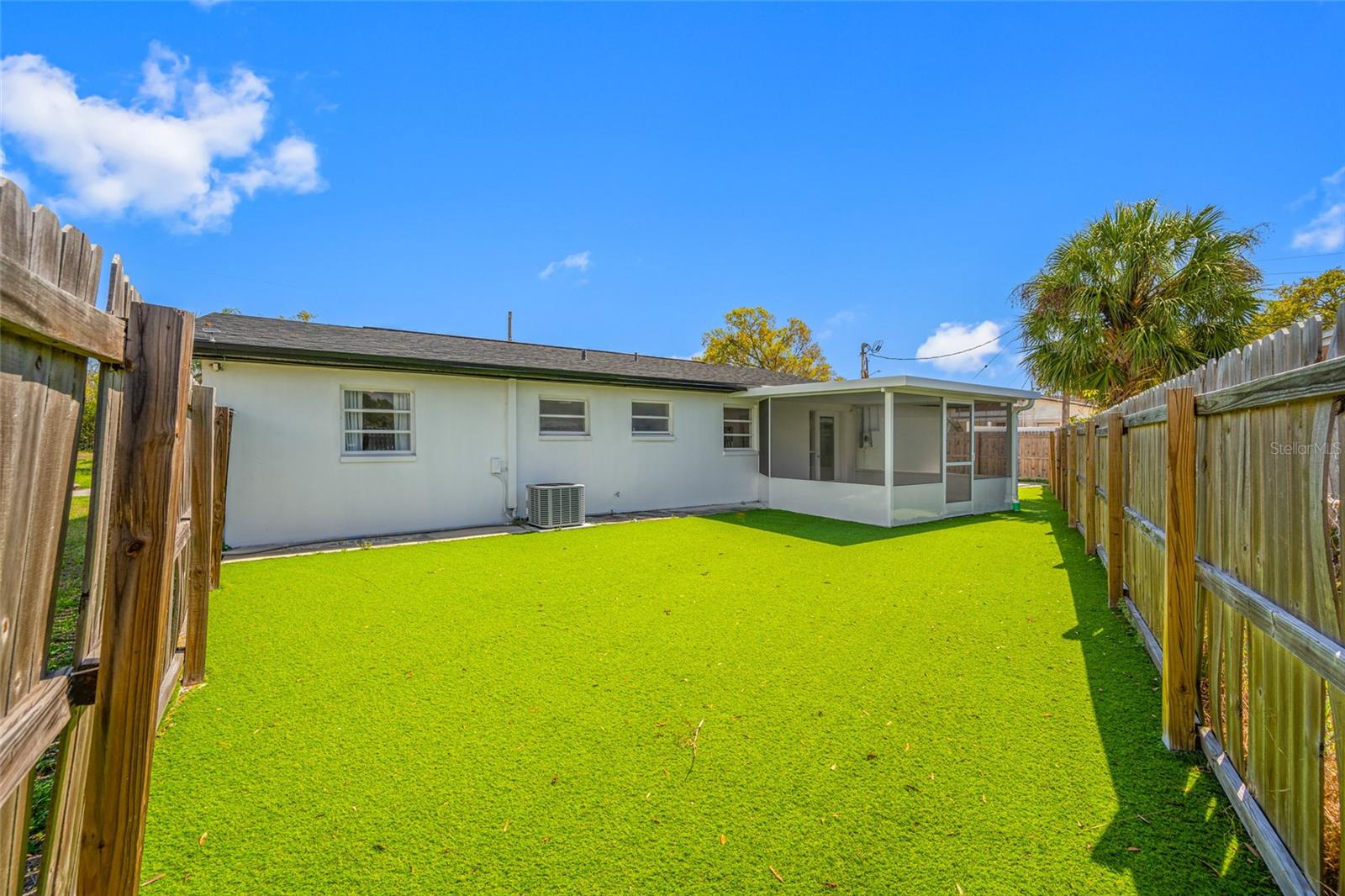 Fenced Backyard with faux grass