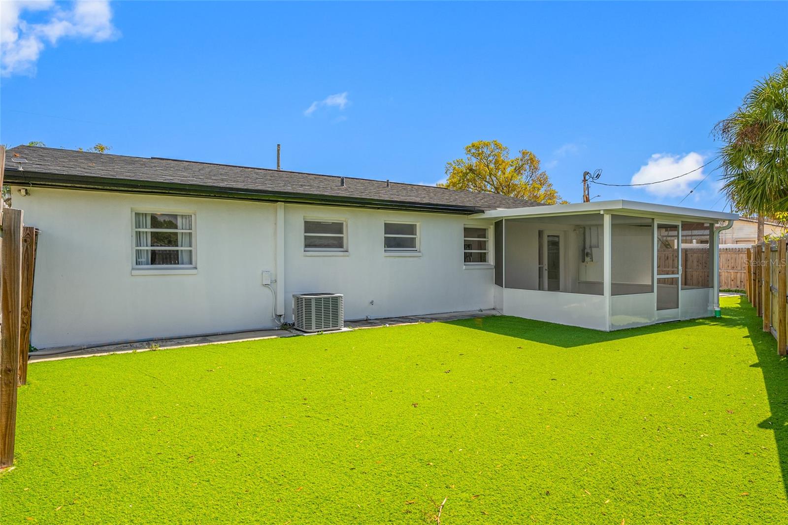 Fenced Backyard with faux grass