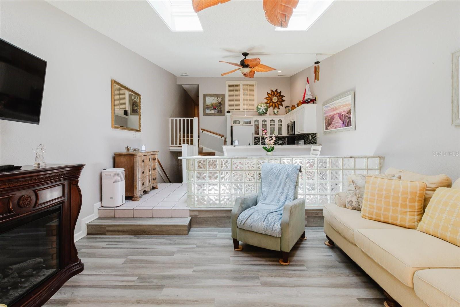 Open Concept Living Room With Luxury Vinyl Floors & Balcony Access. Easy Access to Kitchen