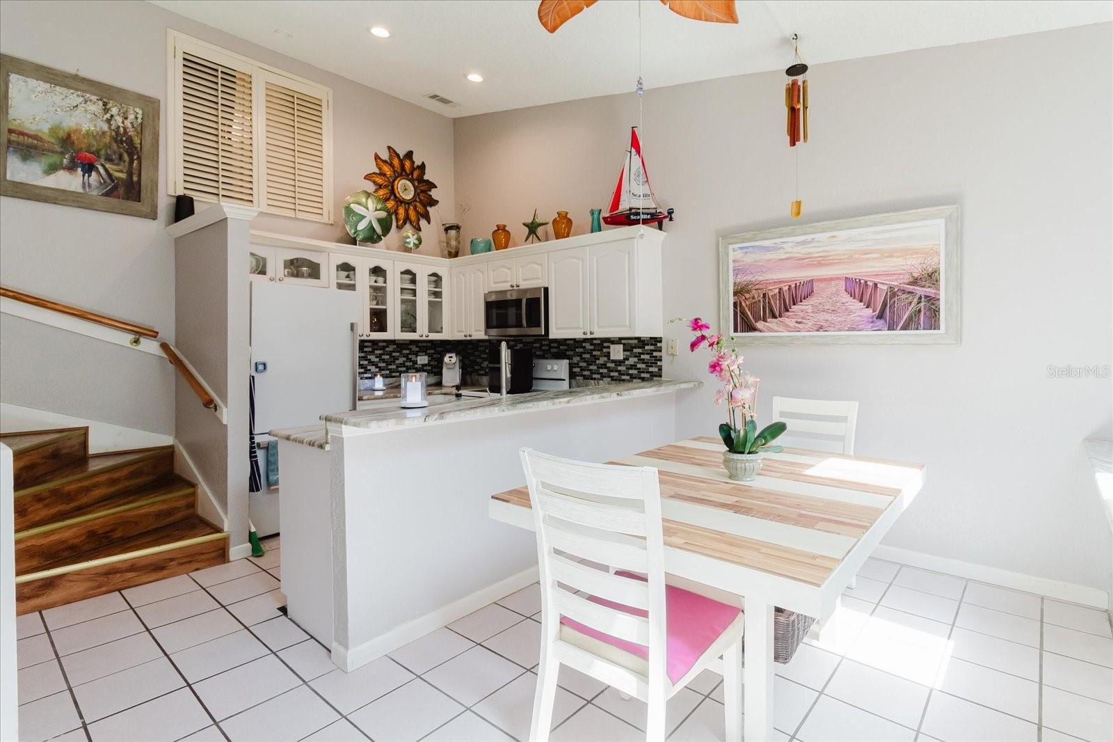 Dining Room With Title Floors and Granite Breakfast Bar