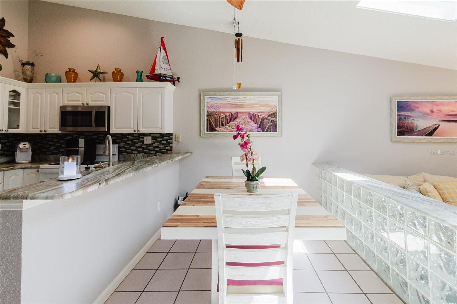 Dining Room With Title Floors and Granite Breakfast Bar