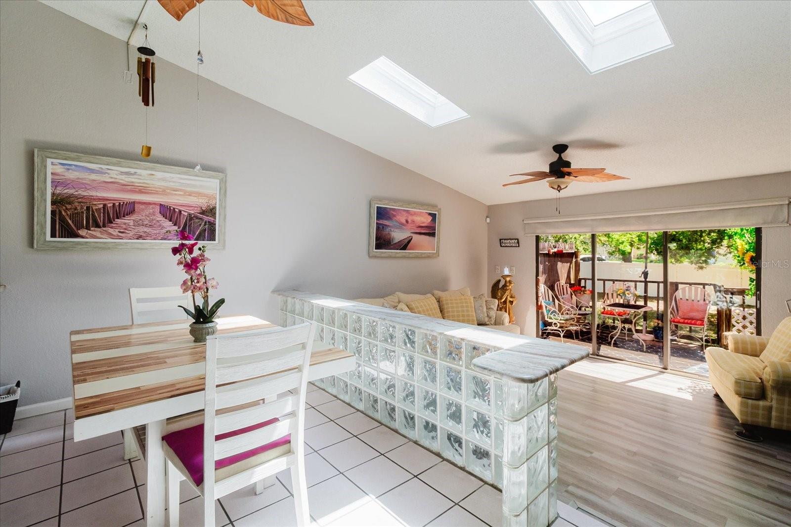 Dining Room With Title Floors and Skylights that Radiate Throughout the Main Living Area