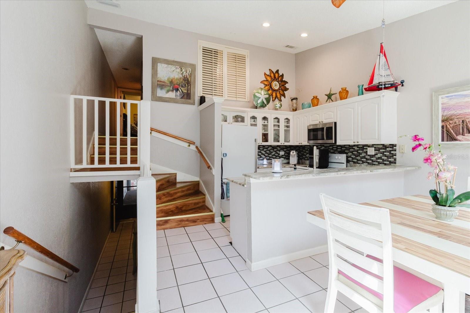 Light and Bright Main Floor. Kitchen and Dining Area Have Tile Floors. Lots of Cabinets & Granite Counters in the Kitchen. Breakfast Bar