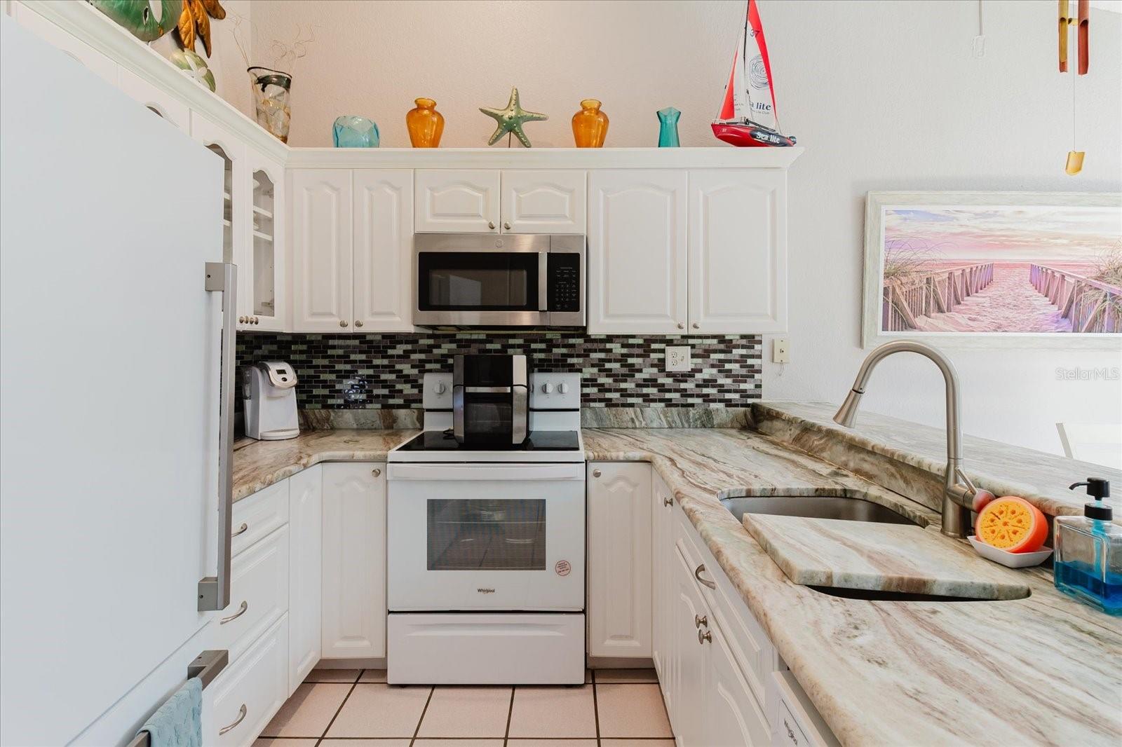 Light and Bright Main Floor. Kitchen and Dining Area Have Tile Floors. Lots of Cabinets & Granite Counters in the Kitchen. Breakfast Bar seats 3 Comfortably