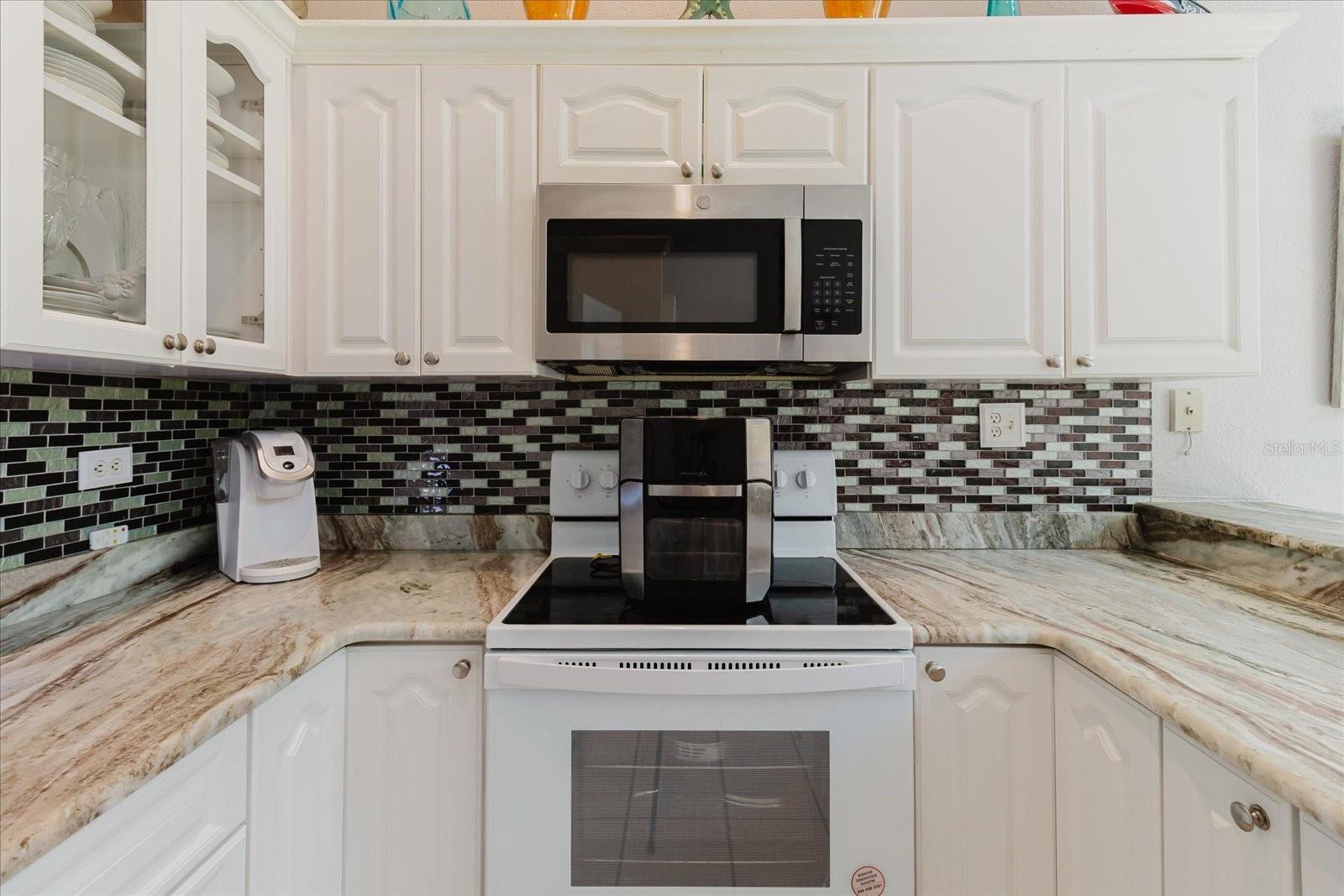 Light and Bright Main Floor. Kitchen and Dining Area Have Tile Floors. Lots of Cabinets & Granite Counters in the Kitchen. Breakfast Bar