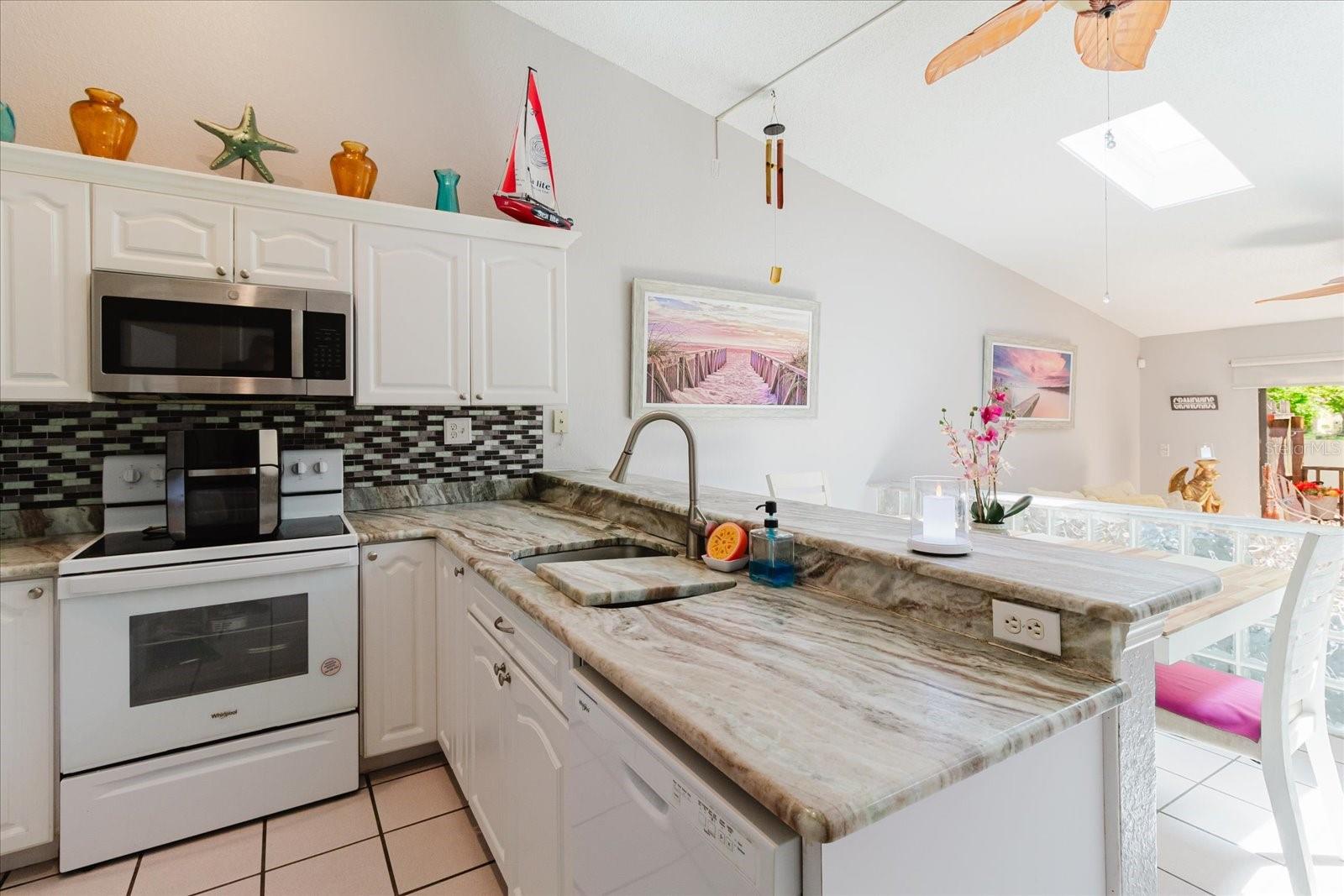 Light and Bright Open Concept Main Floor. Kitchen and Dining Area Have Tile Floors. Breakfast Bar Seats 3 Comfortably. Skylights Provide Natural Sunlight.