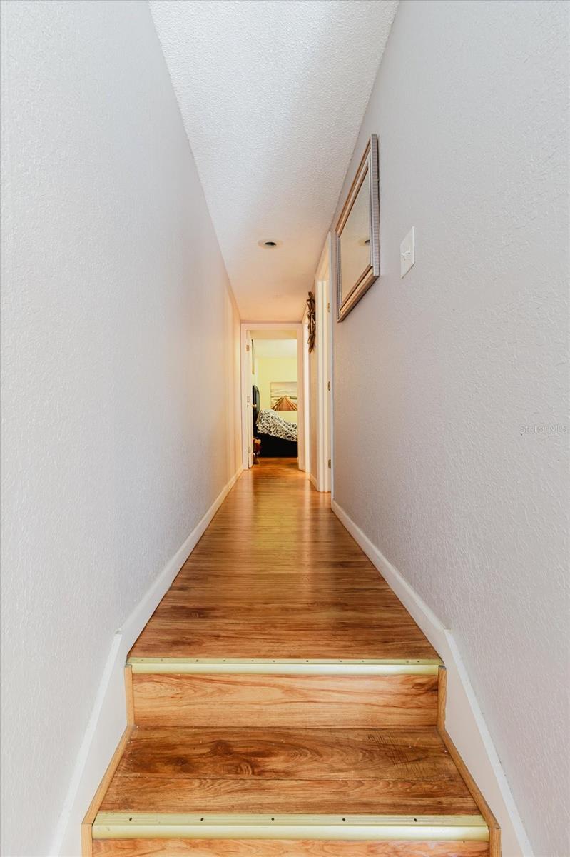 Stairs and Hallway With Luxury Vinyl Floors, Leads to the Third Floor Where Both Bedrooms and Both Bathrooms Are Located.