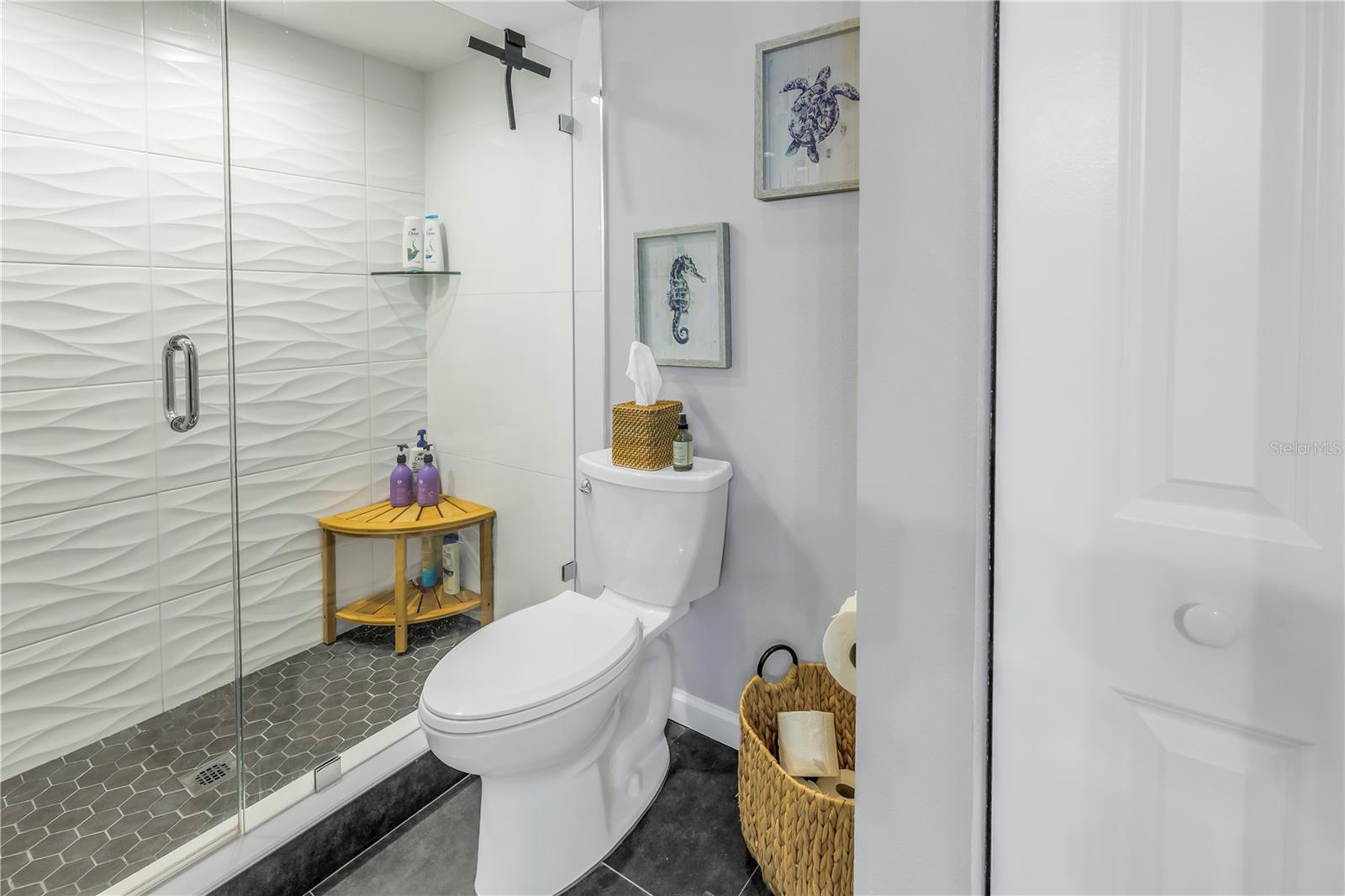 Private Seamless Glass Shower and Toilet Room.  Modern Updated Tile Walls and High Ceiling
