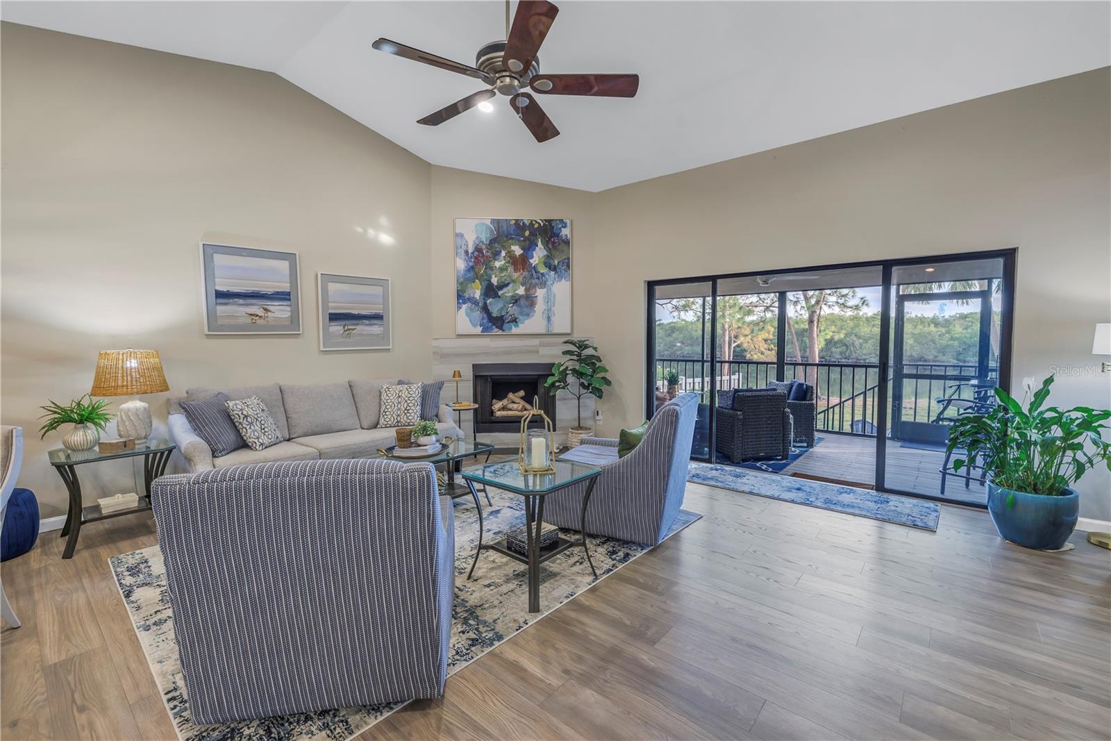 Soaring Vaulted Ceilings, Updated Luxury Vinyl Flooring, Wood Burning Fireplace and Water Views