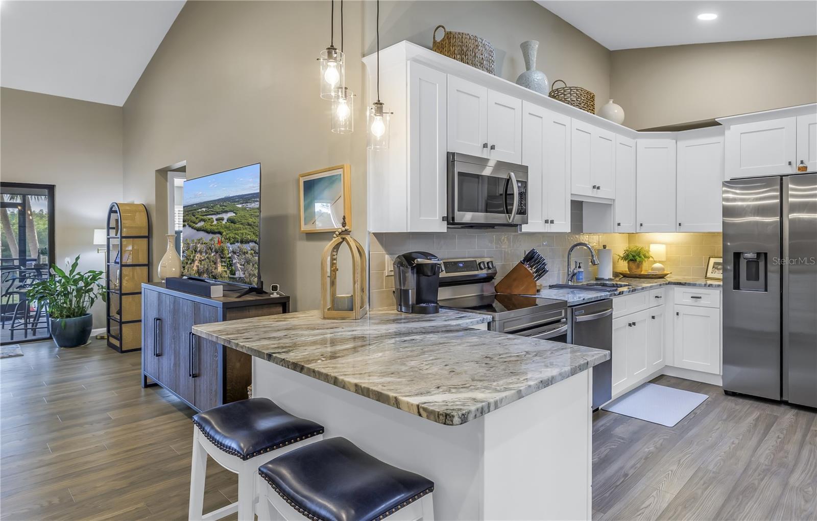 High Ceilings in this Fully Updated Kitchen with Granite Counters, Beautiful Backsplash and Stainless appliance