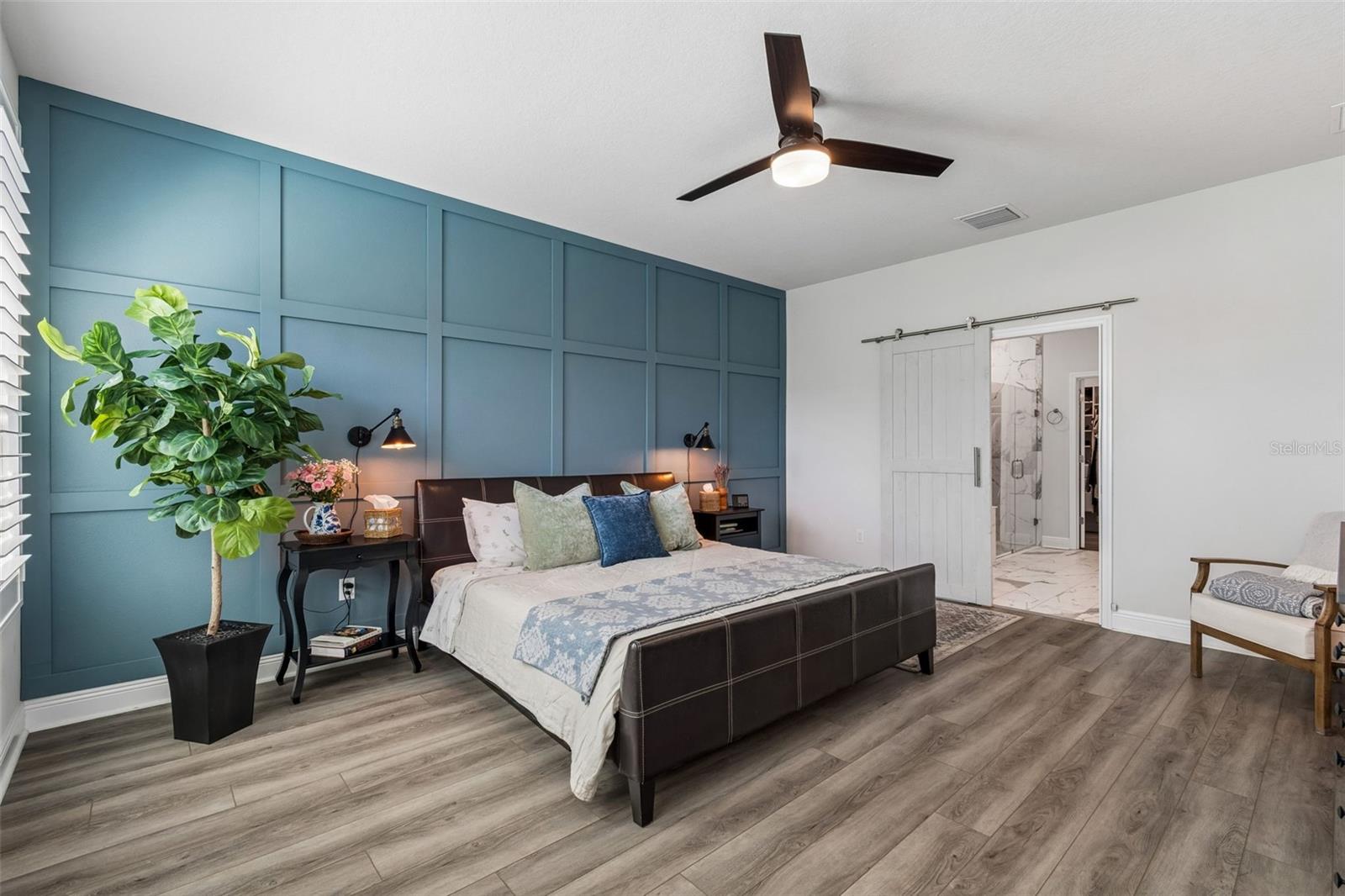 Spacious Primary bedroom with designer accent wall