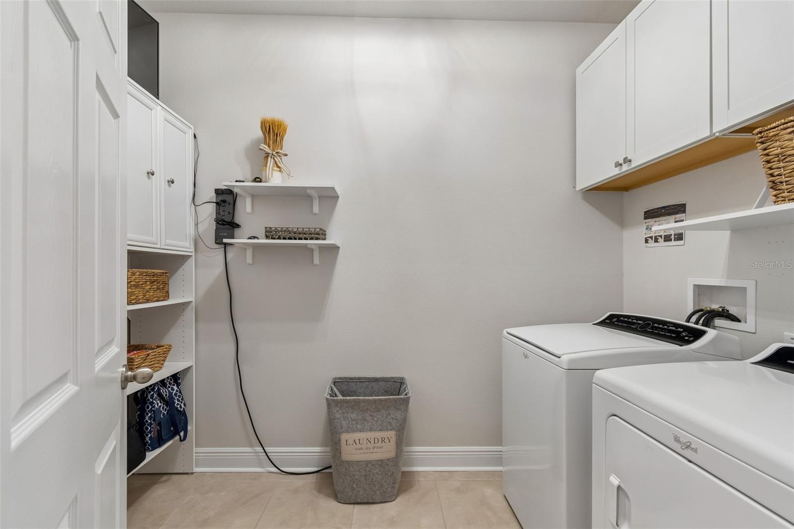 Laundry Room with built in cabinets & shelves