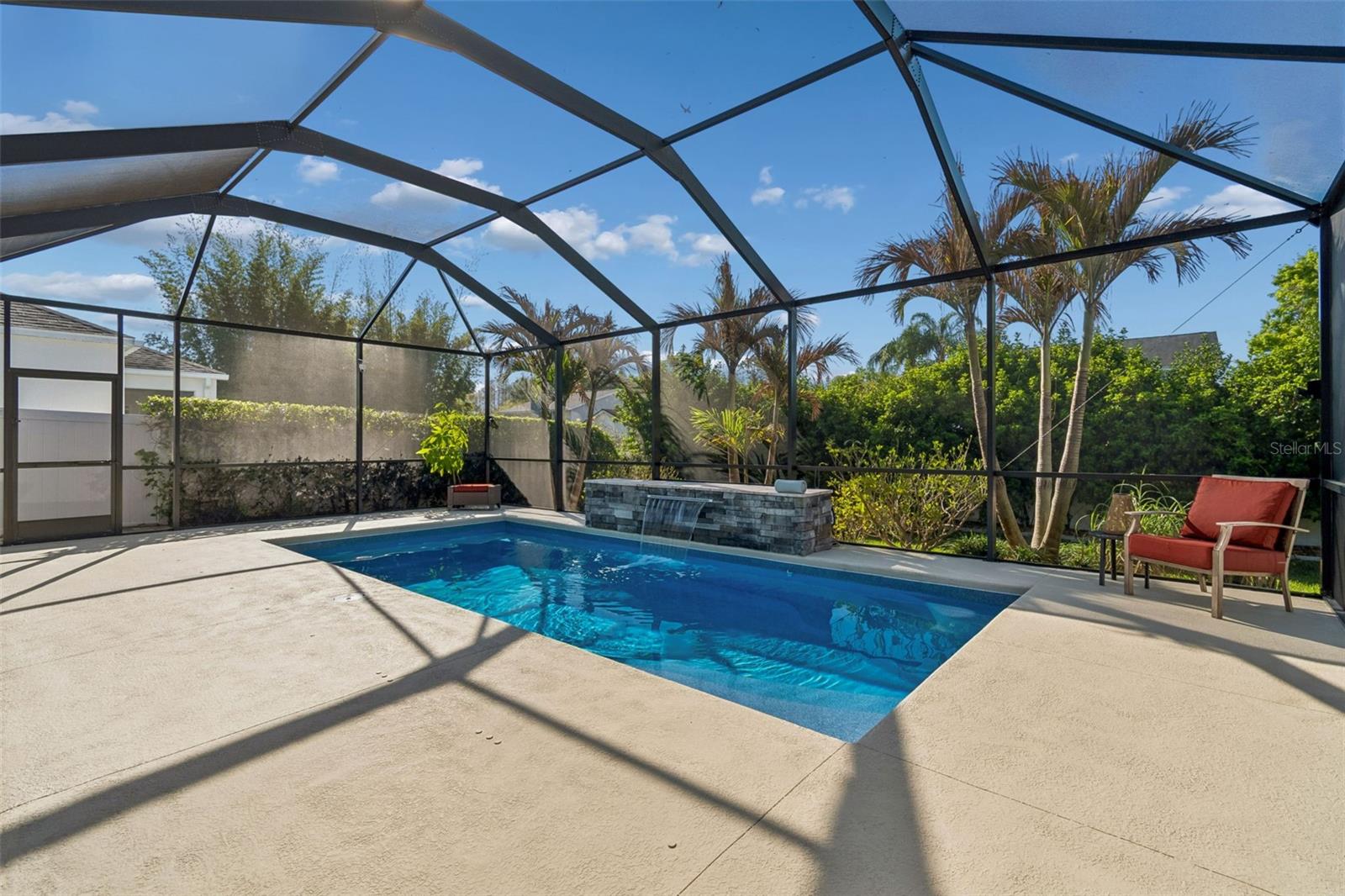 Pool with waterfall and tropical landscaping