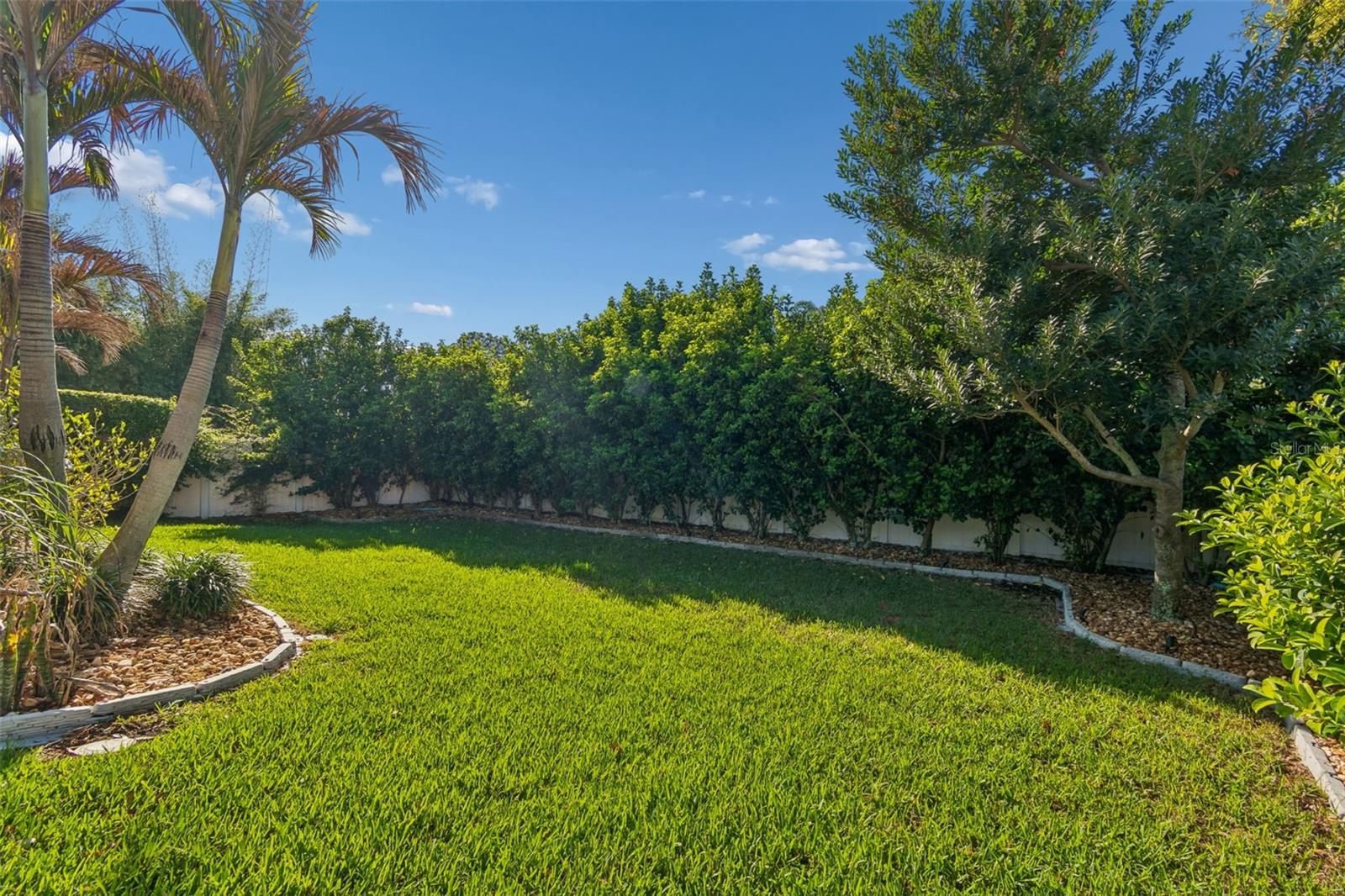 Fenced backyard with manicured landscaping