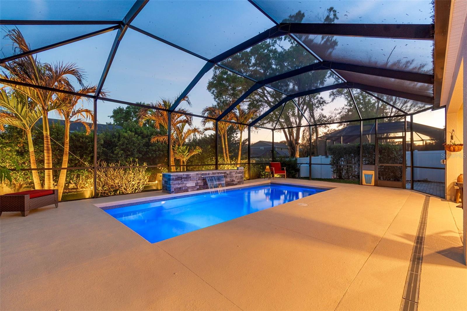 Pool with waterfall and landscape lighting