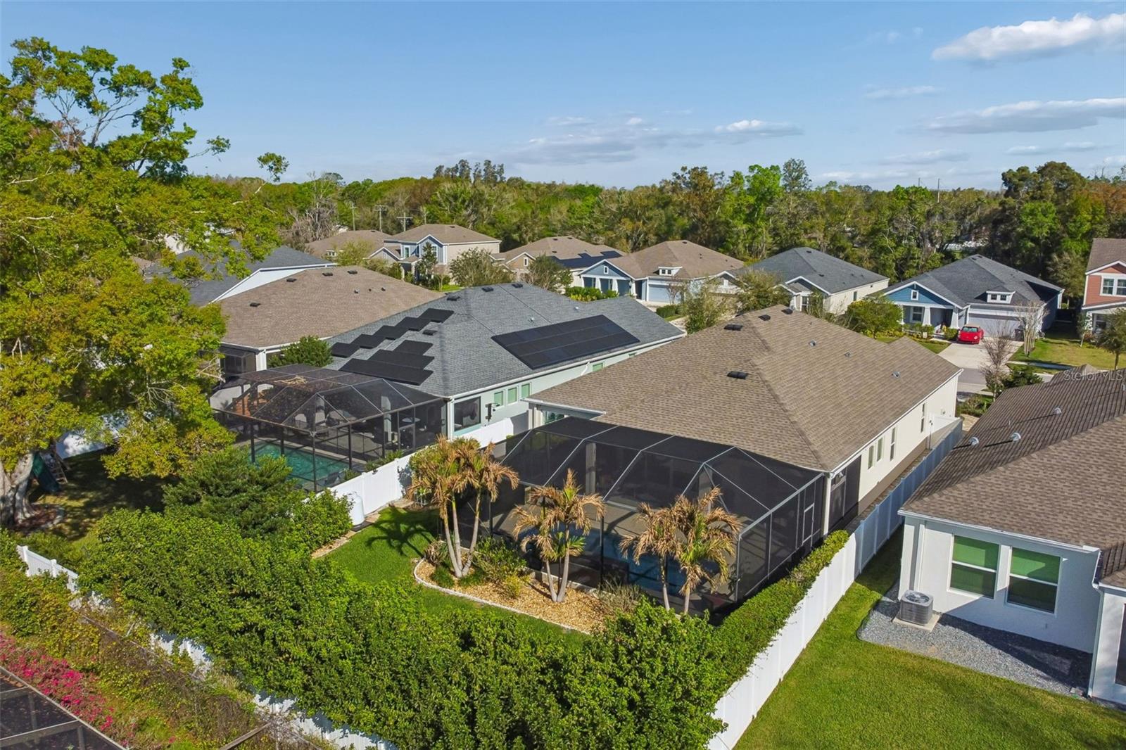 Aerial view of home and fenced backyard