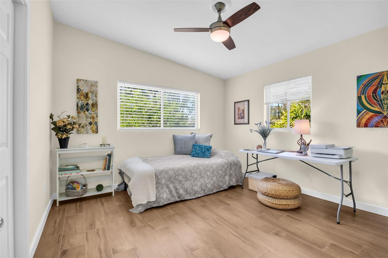 Spacious guest suite featuring vaulted ceilings, a large built-in closet, and oversized windows with private backyard green views~