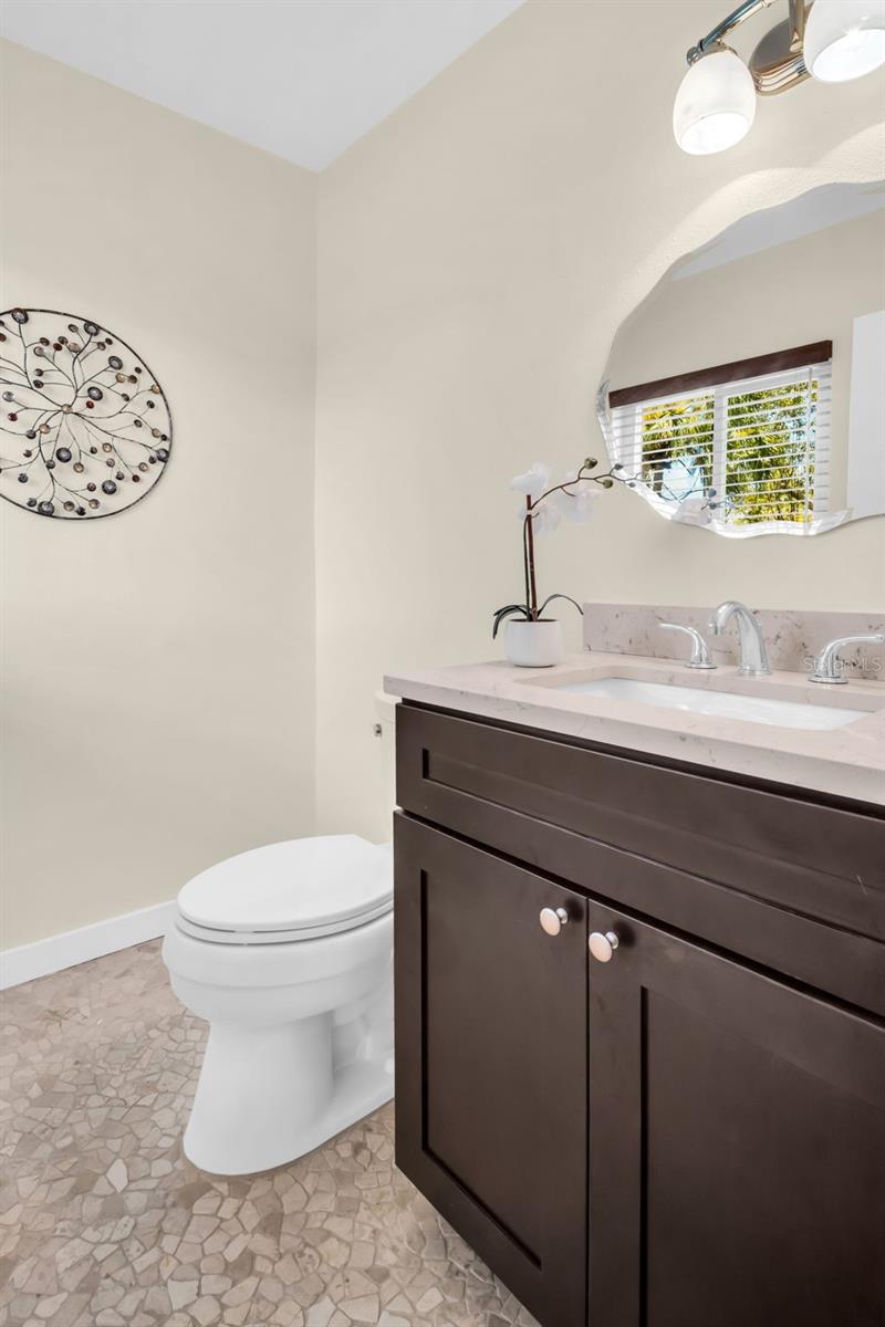 Master bath with new vanity, stone countertop, and updated lighting~