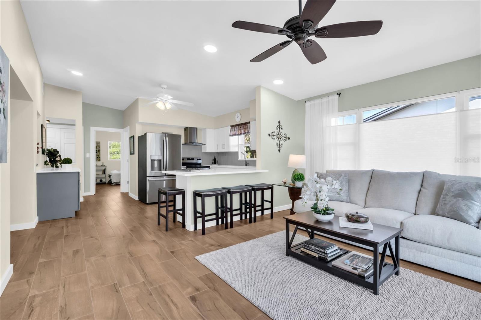 Stunning front entry to the open & spacious floor plan with wood-like tile flooring flowing throughout~