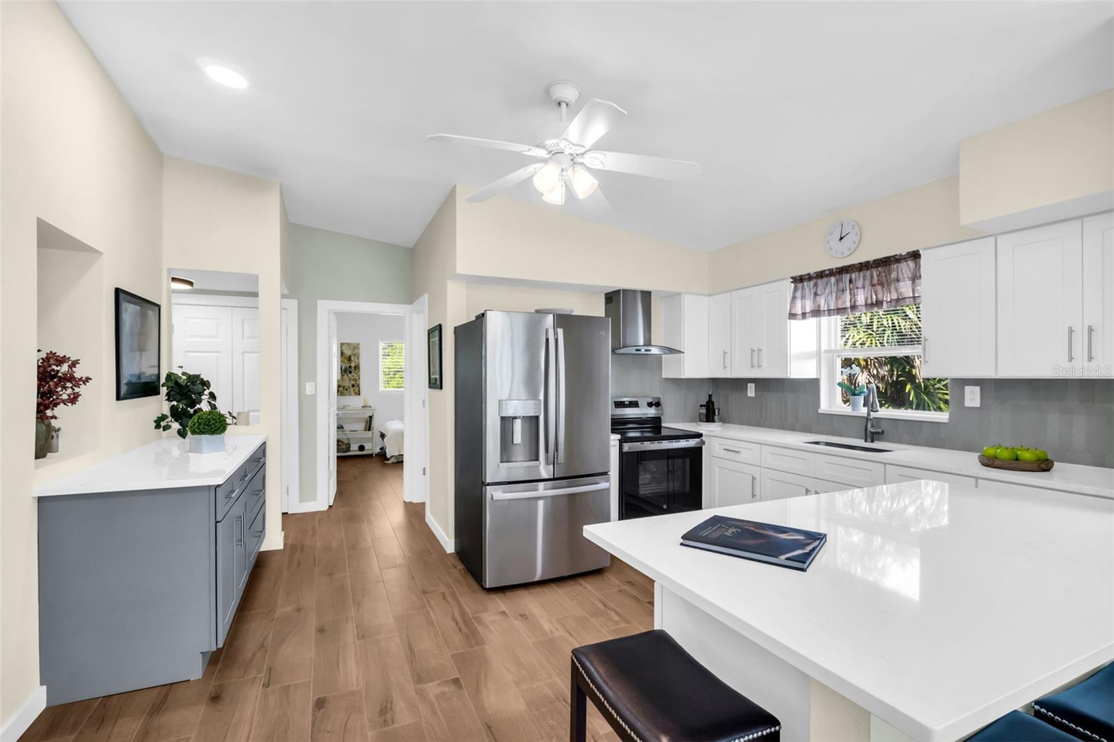 Stunning kitchen renovation with quartz countertops, new cabinetry, and new tile backsplash~