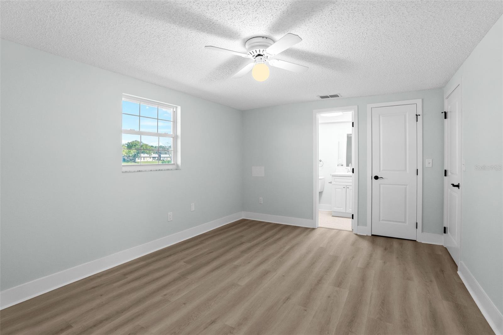 Primary Bedroom with ensuite bath and walk-in closet