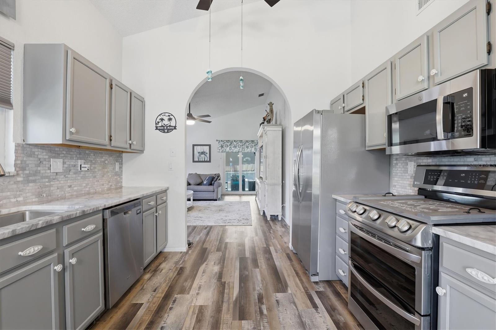 Well-appointed kitchen with granite countertops, newer appliances, stylish tile backsplash.