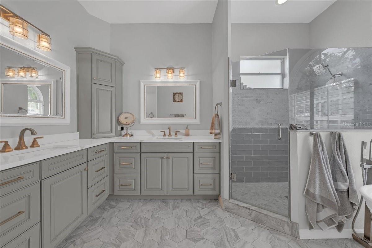 En-suite bathroom featuring double sink vanity.