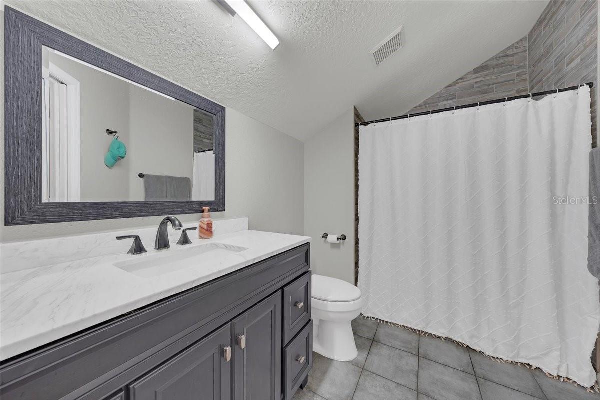 Elegant private bathroom connected to the upstairs room