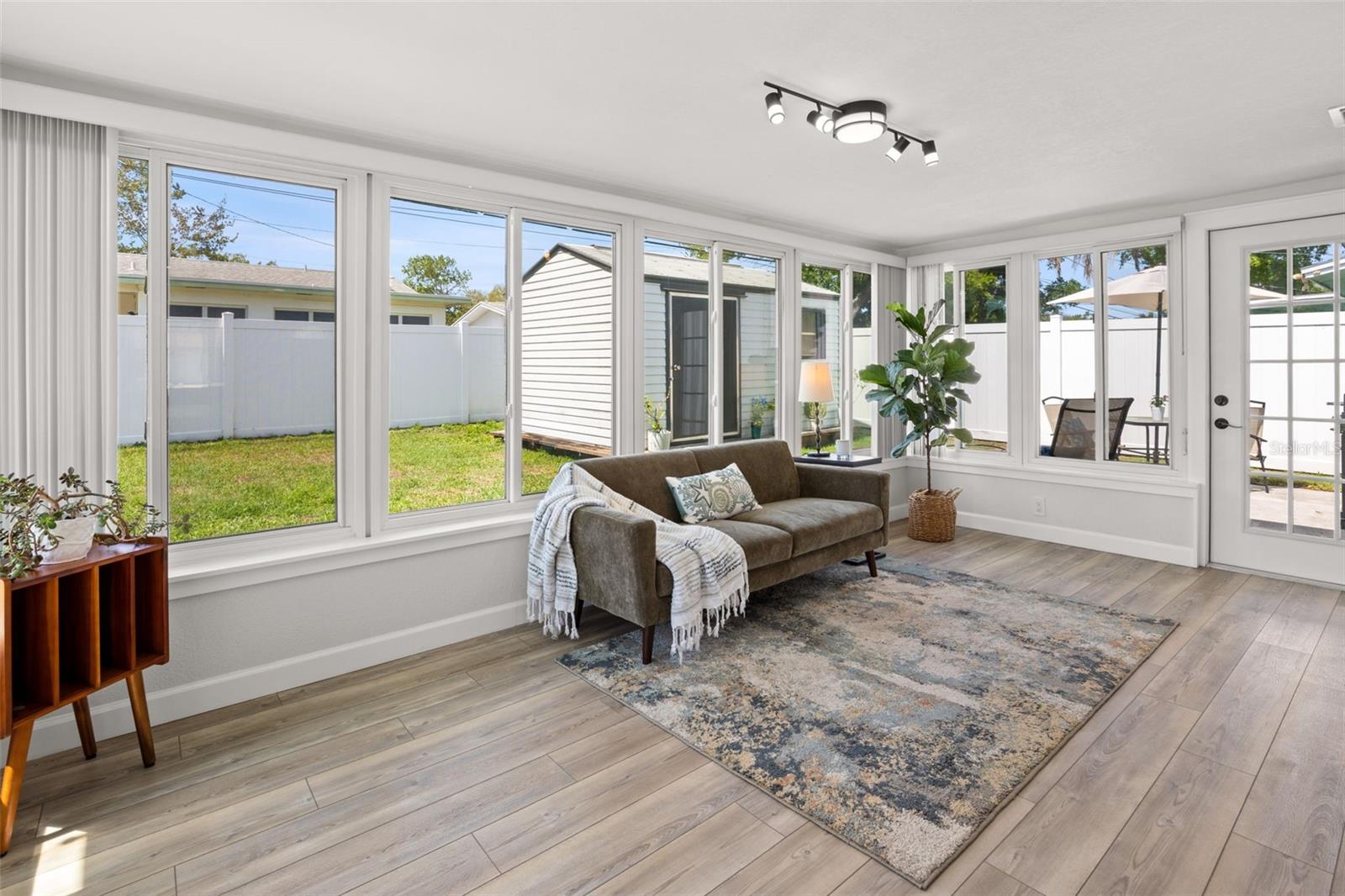 Fully enclosed Florida room, looking out to patio, shed (with electricity) and fully fenced back yard.