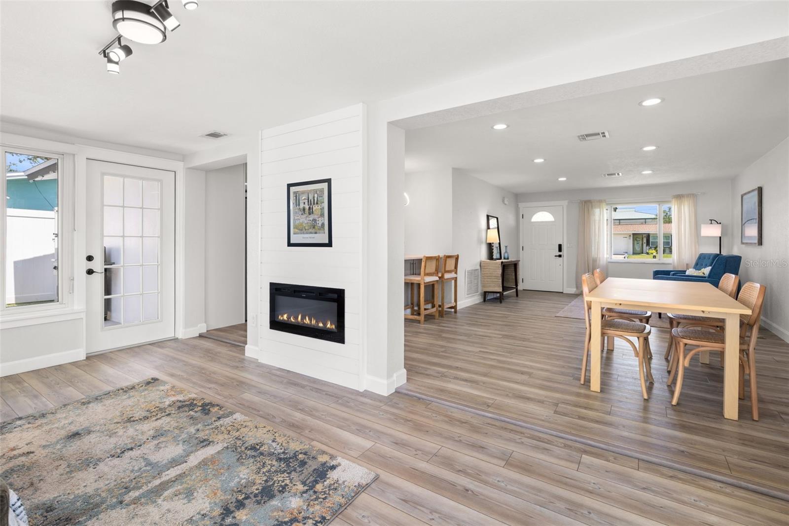 Florida room features built-in electric fireplace.