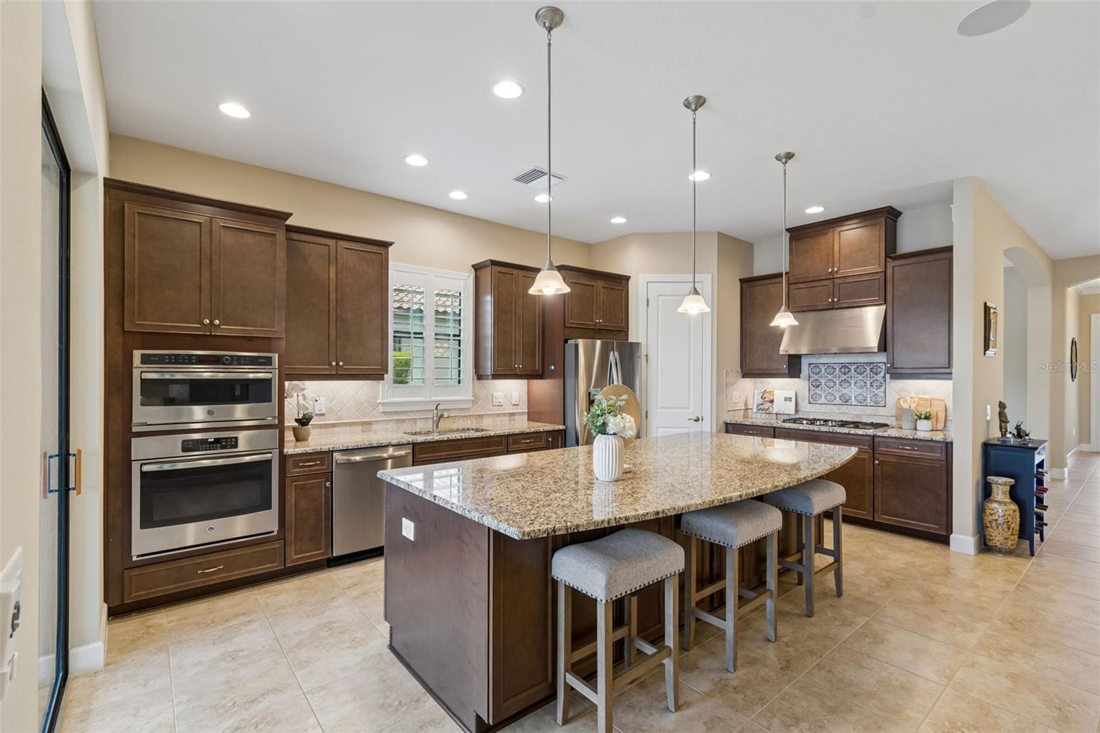 Spacious kitchen with large center island, abundant cabinetry, and functional layout for everyday living. Enjoy your gormet kitchen with upgraded appliances, and walk in pantry. Plus spacious island with storage on both sides of the island