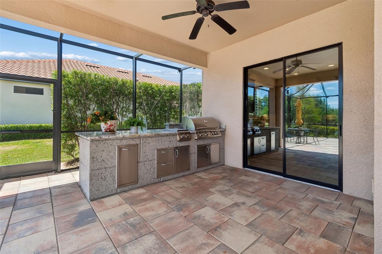 Covered outdoor kitchen area adds convenience for year-round use.