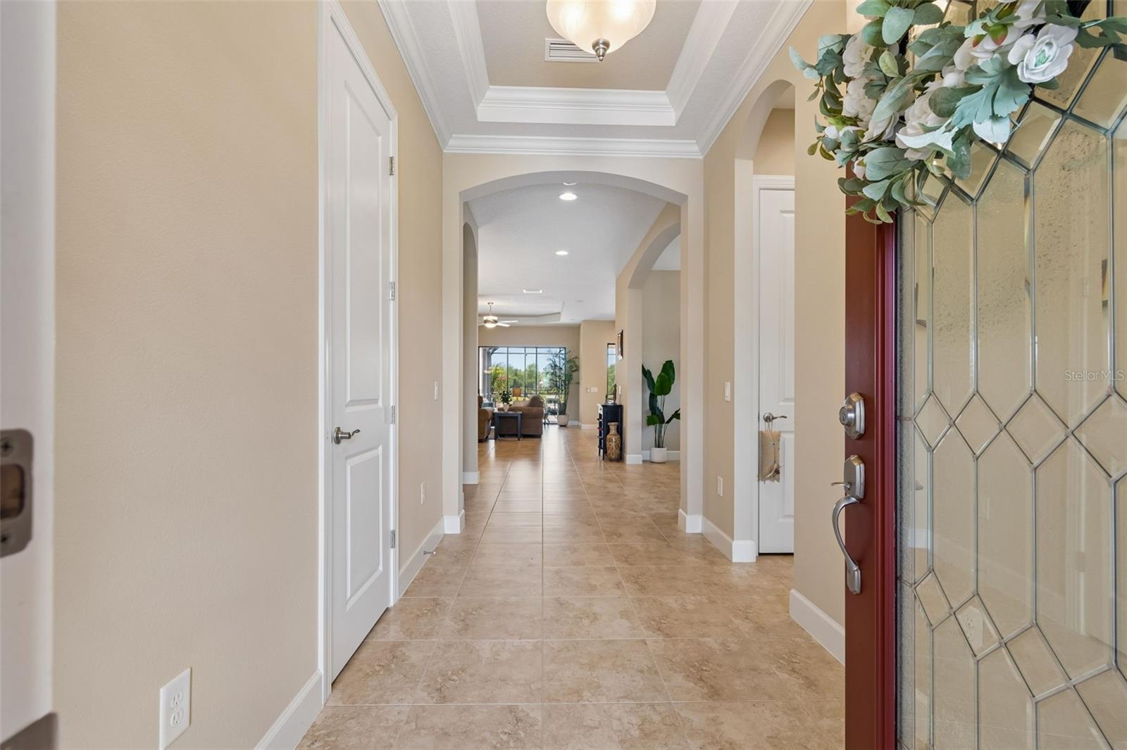 Inviting entry with open sightlines leading directly to the main living space and water views beyond.