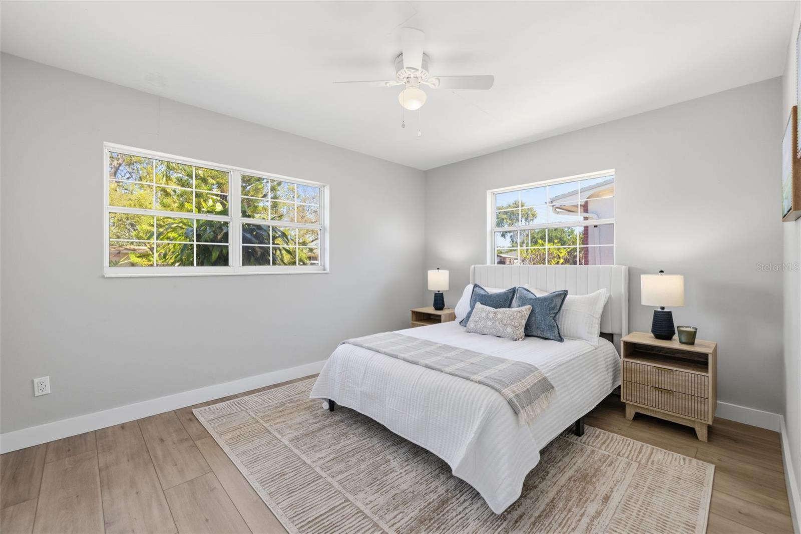 Primary bedroom featuring luxury vinyl flooring and neutral finishes.