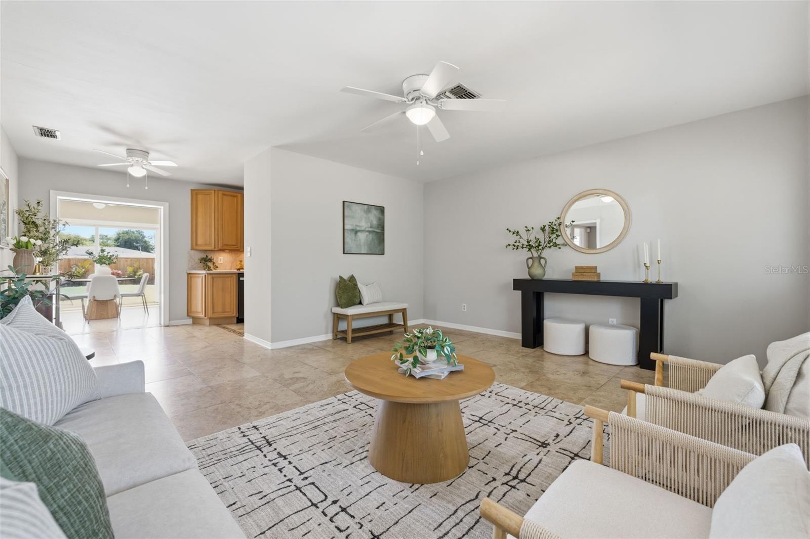 Bright living room with tile flooring and abundant natural light.