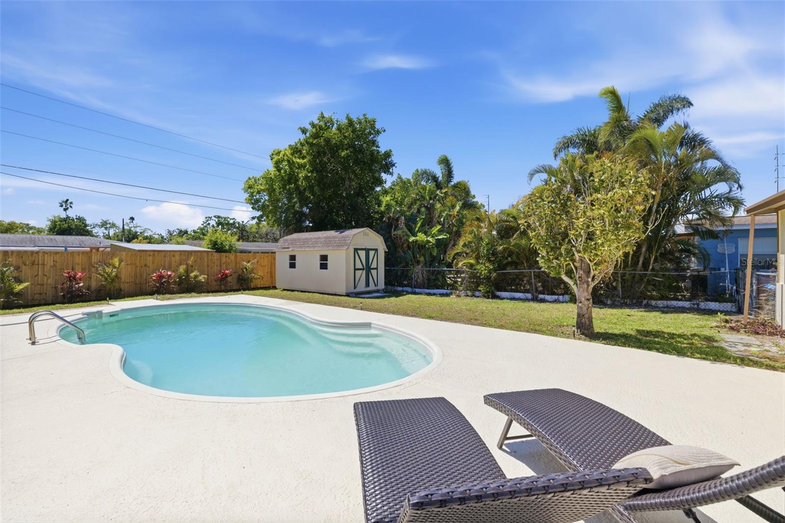 Private backyard pool area with room for lounging and outdoor gatherings.