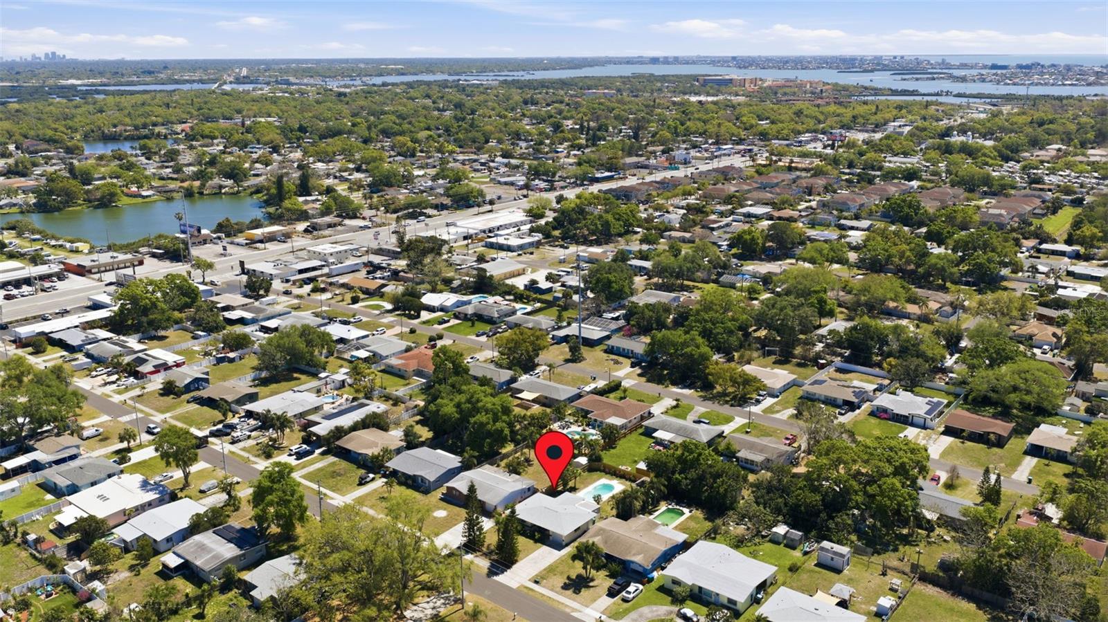 Overhead perspective highlighting nearby residential area and coastal waterways.