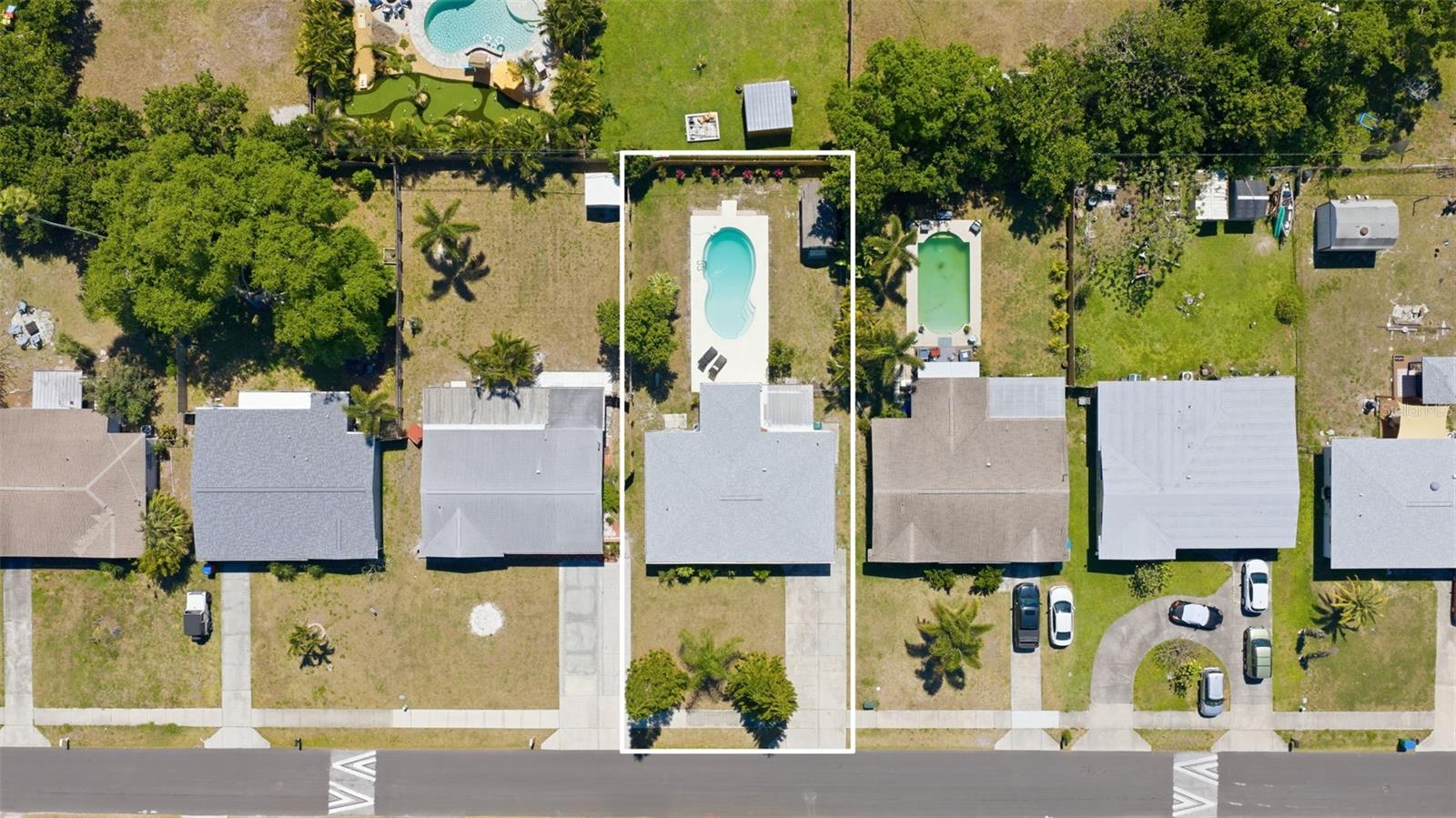 Overhead view of the property showcasing the pool and backyard layout.