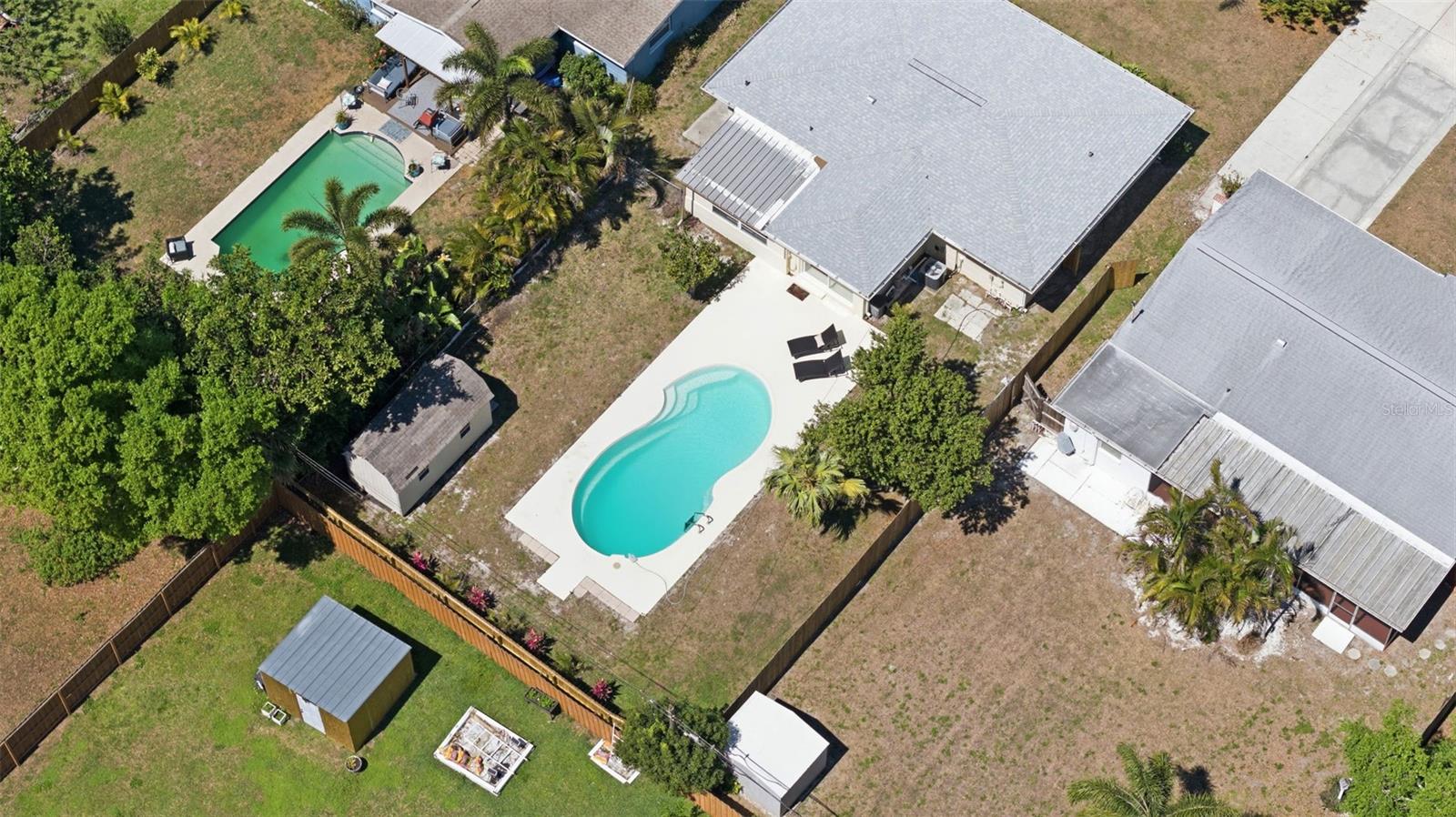Bird’s-eye view showcasing the backyard retreat with pool and spacious outdoor area.