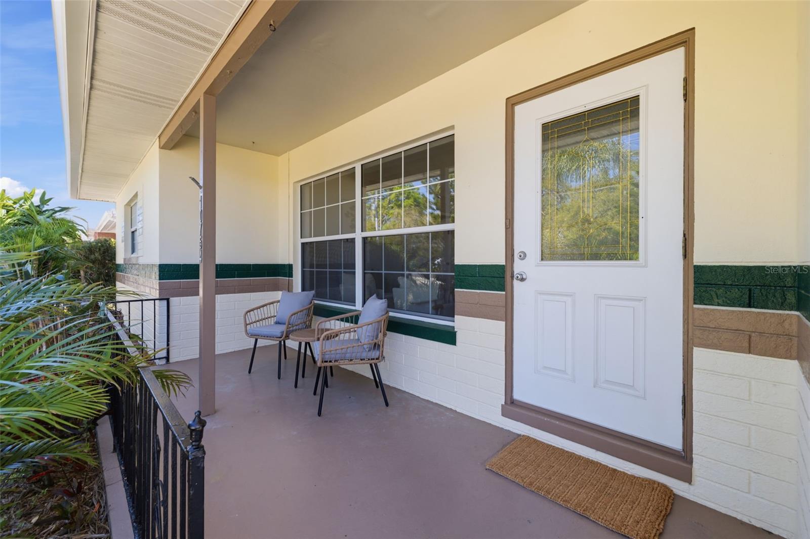 Covered front porch ideal for enjoying Florida’s year-round weather.