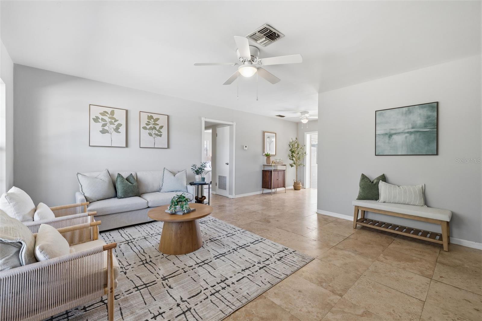 Spacious living area with neutral tones and easy-care tile flooring.