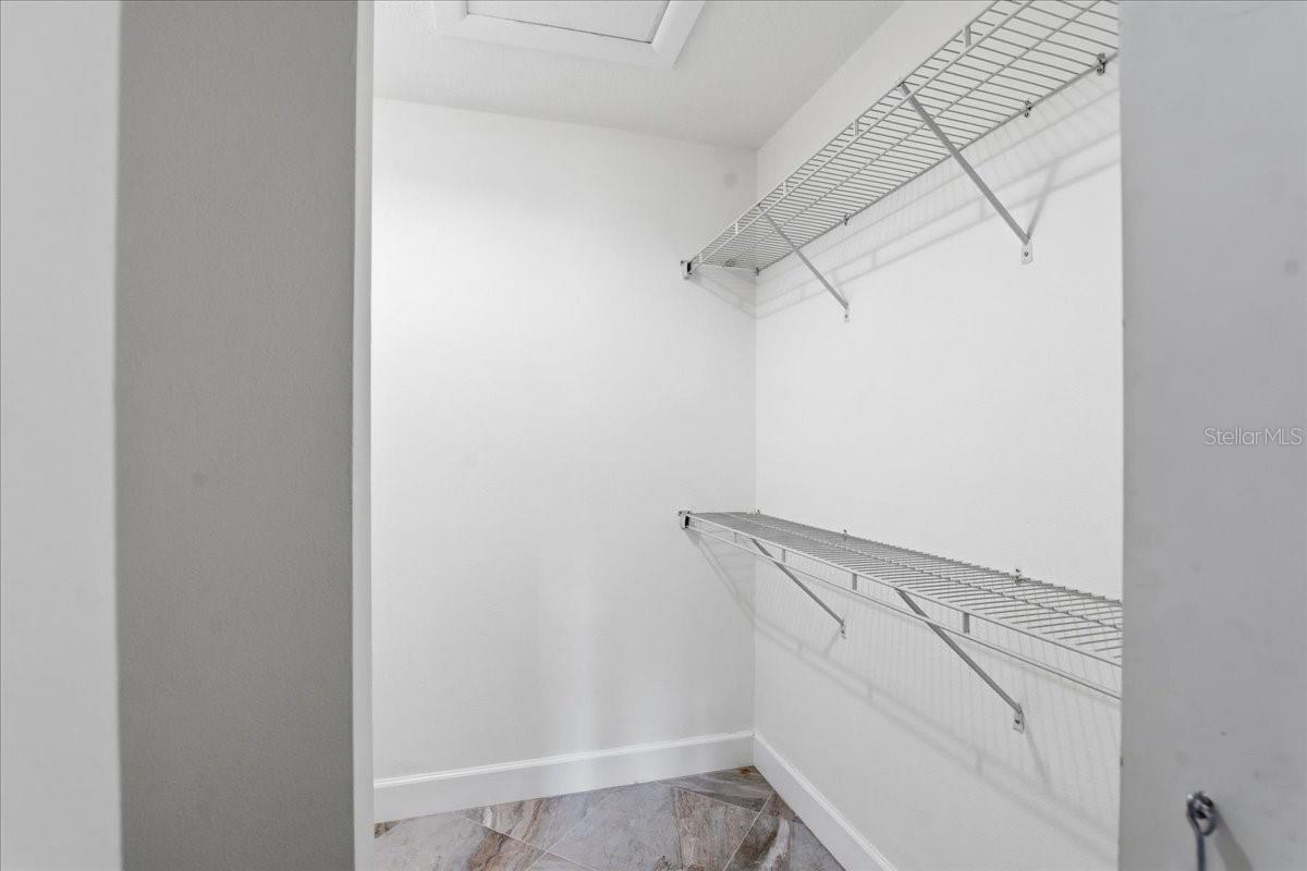 Primary bedroom walk in closet