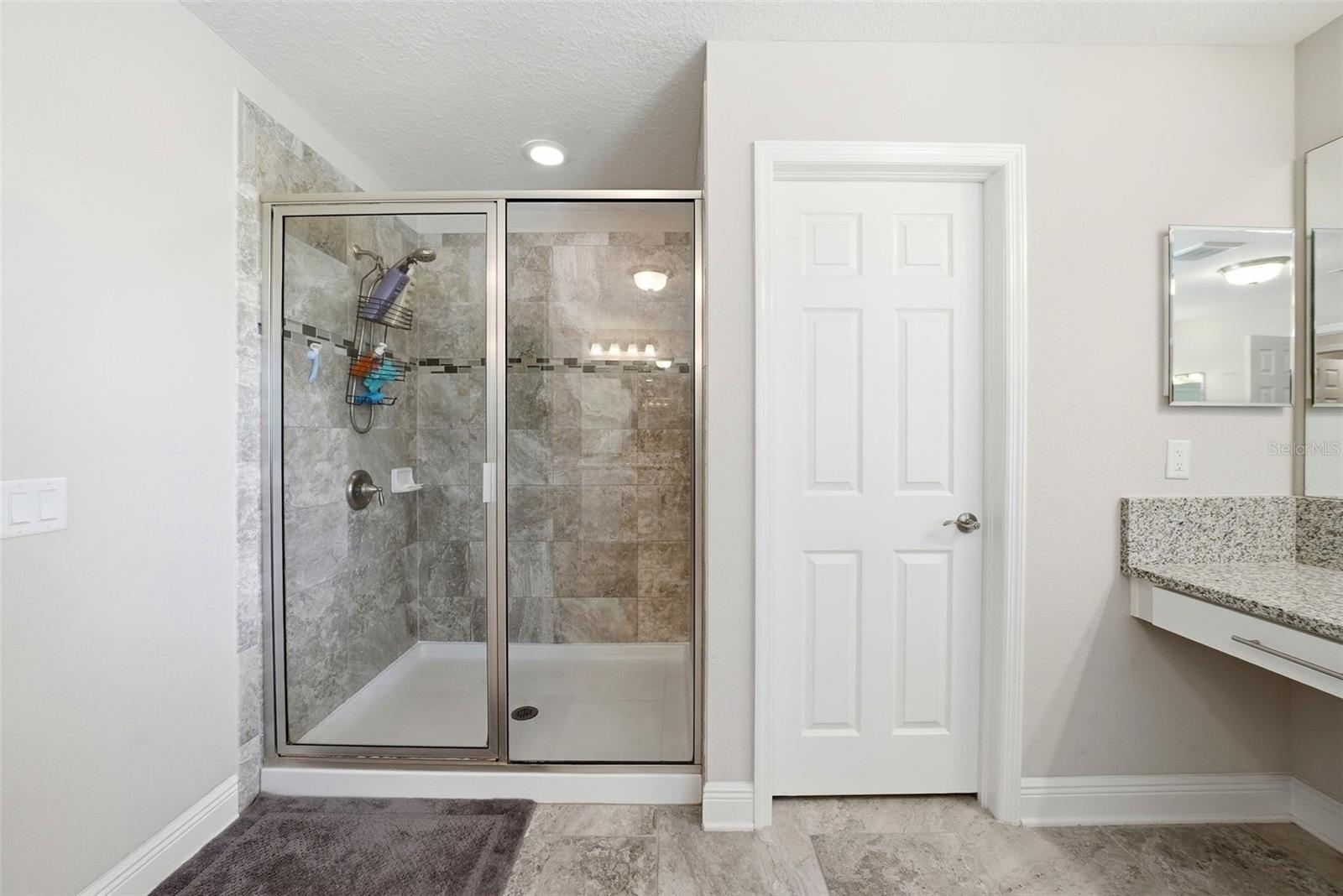 The en suite bathroom offers a private, spa-like retreat, thoughtfully designed for comfort and convenience with well-appointed finishes and a seamless connection to the Primary bedroom.