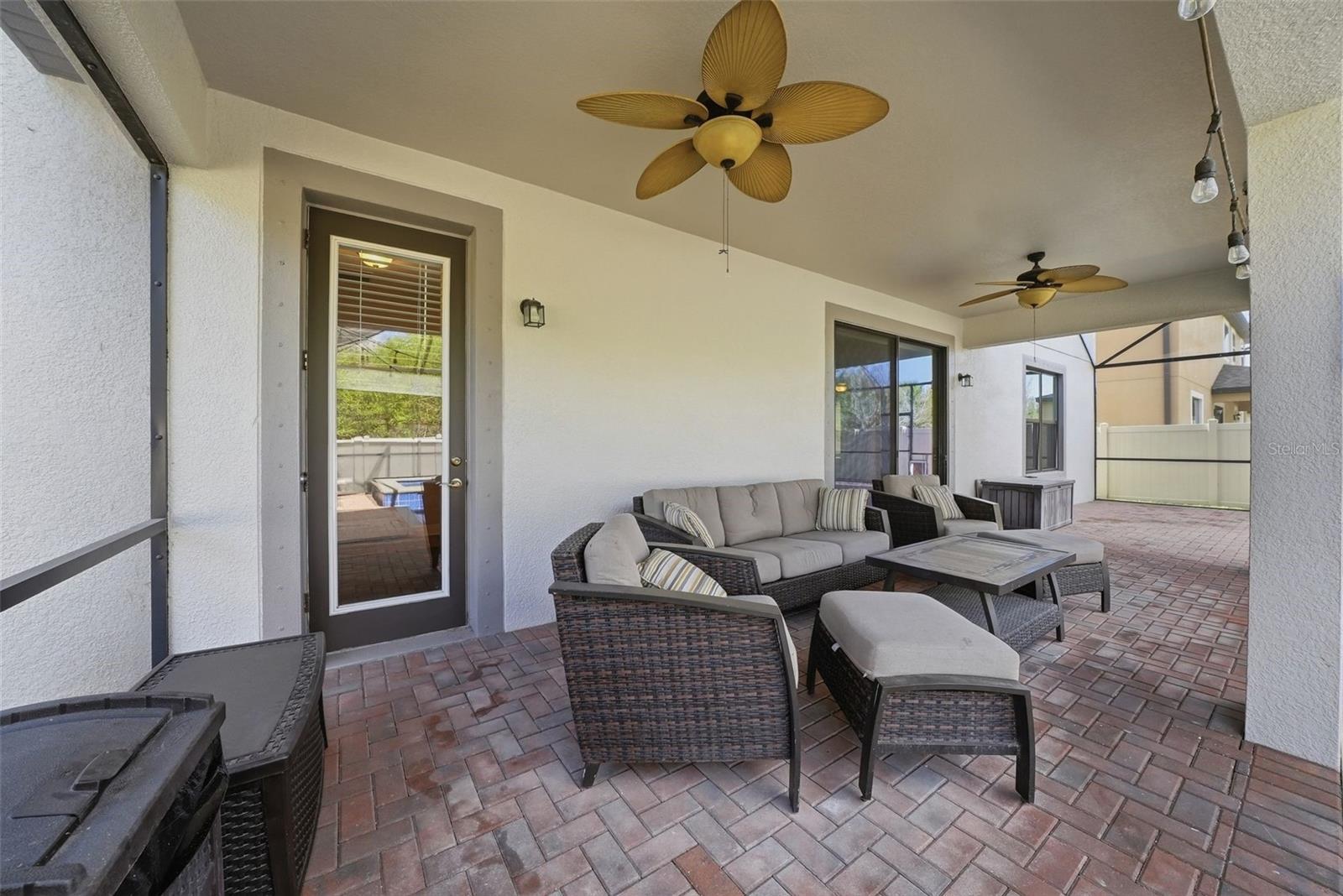Enjoy your own private outdoor retreat featuring a screened-in lanai with elegant pavers, a heated pool and spa, and no rear neighbors—offering the perfect blend of comfort, privacy, and year-round relaxation.