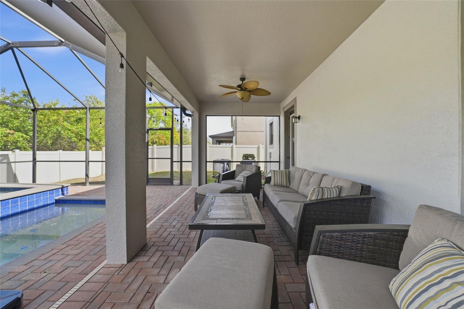 Enjoy your own private outdoor retreat featuring a screened-in lanai with elegant pavers, a heated pool and spa, and no rear neighbors—offering the perfect blend of comfort, privacy, and year-round relaxation.
