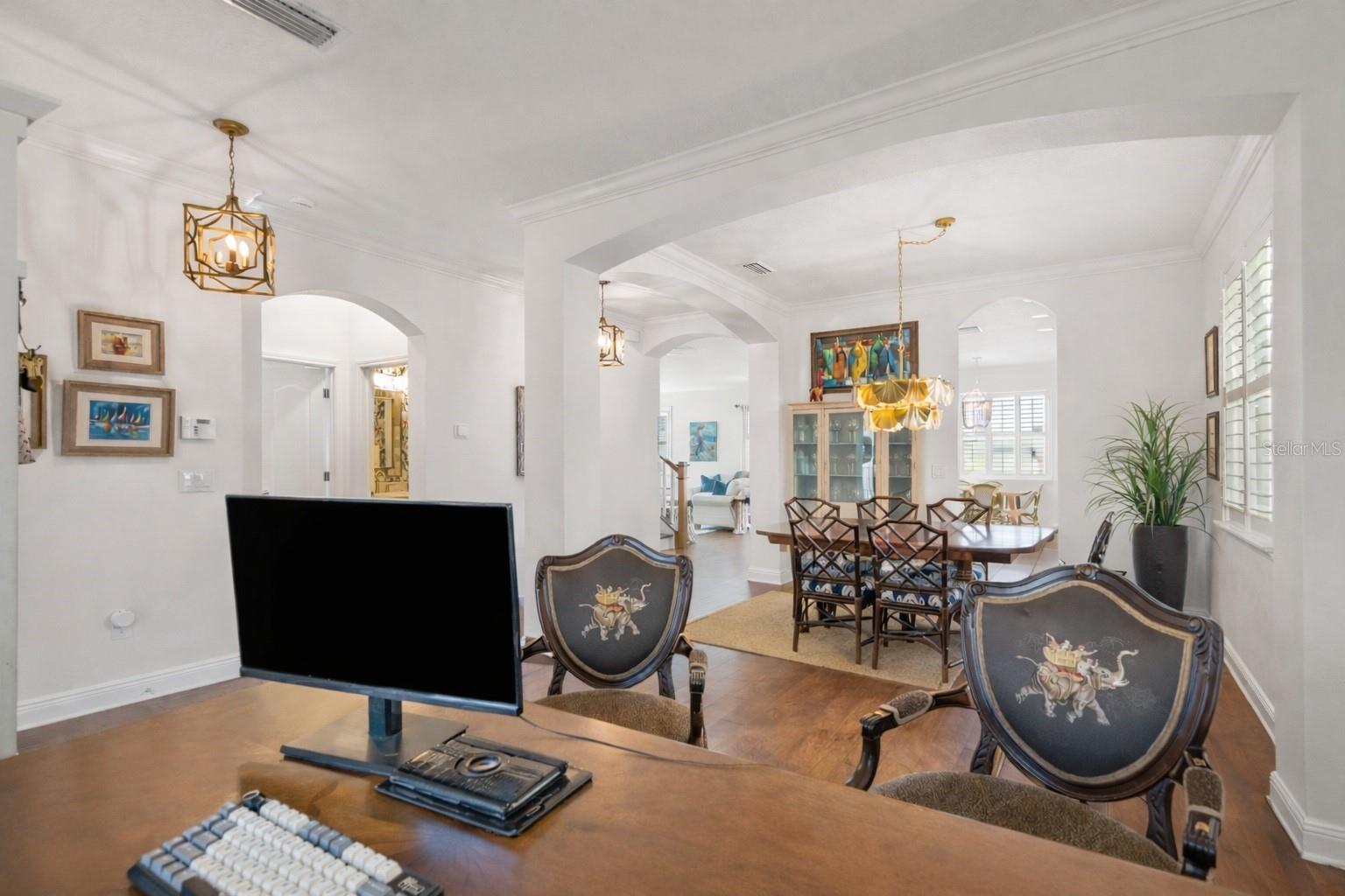 Office area off entry open to dining area