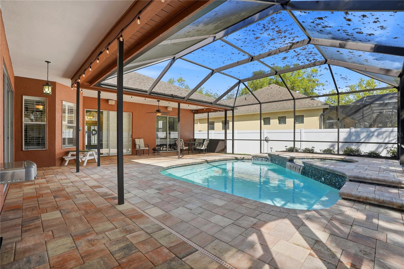 Pool with heated spill over spa with an elevated deck for lounging